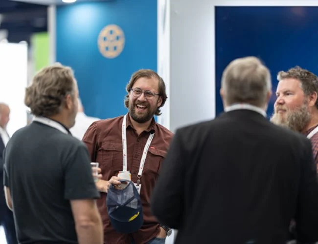Image of geophysicists standing in a circle talking and laughing together