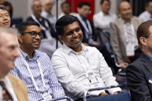 Photo of smiling geophysicists in audience to a conference session