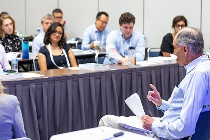 Instructor seated with geophysicists